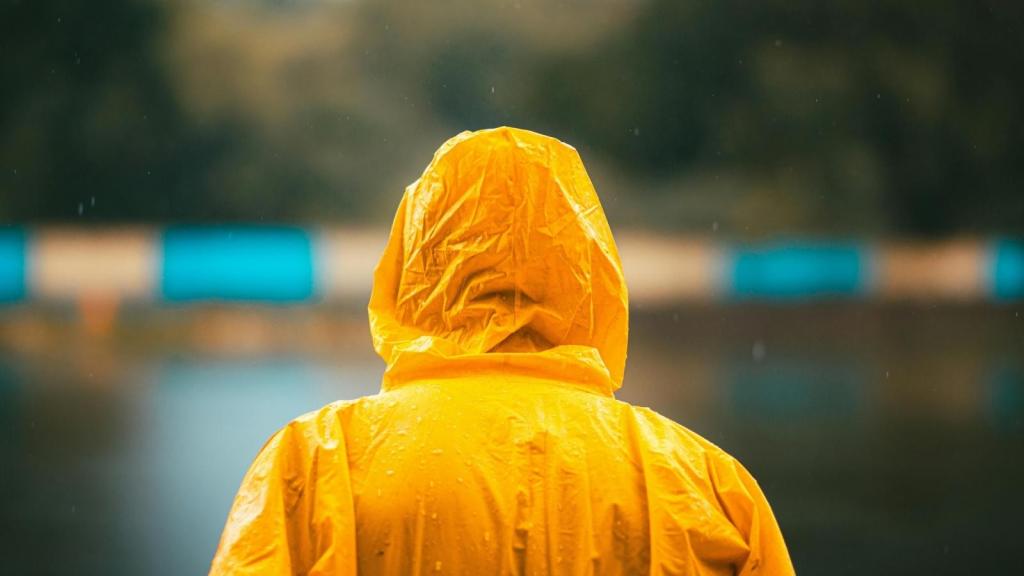 Man walking in the rain wearing a poncho