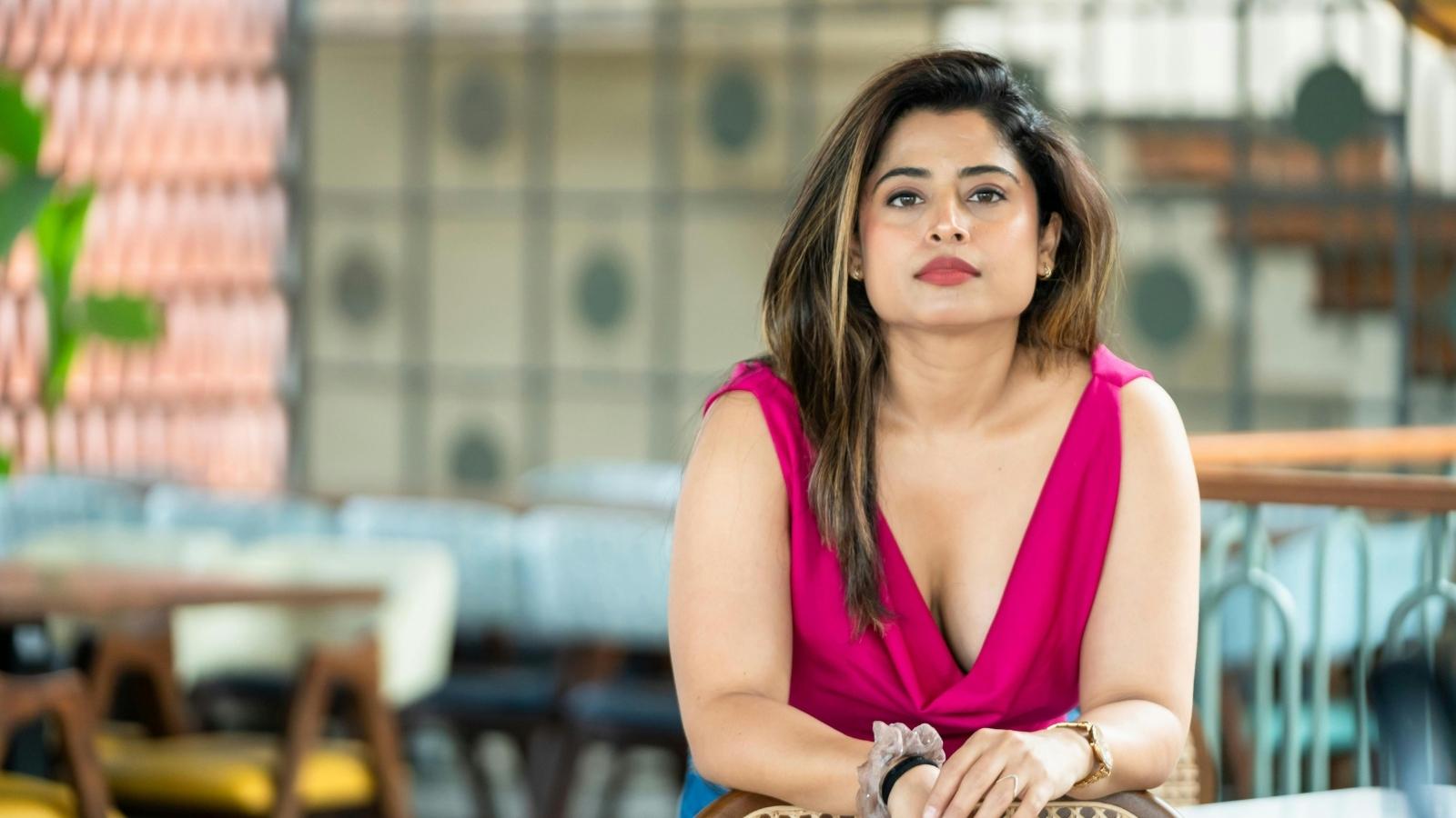 Woman in pink dress, stressed out by her friend
