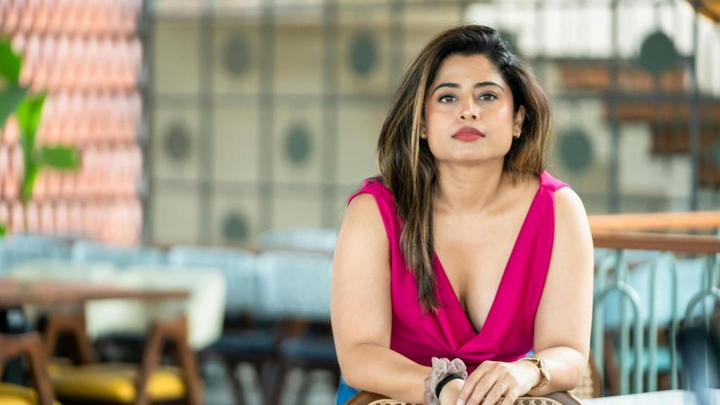 Woman in pink dress, stressed out by her friend