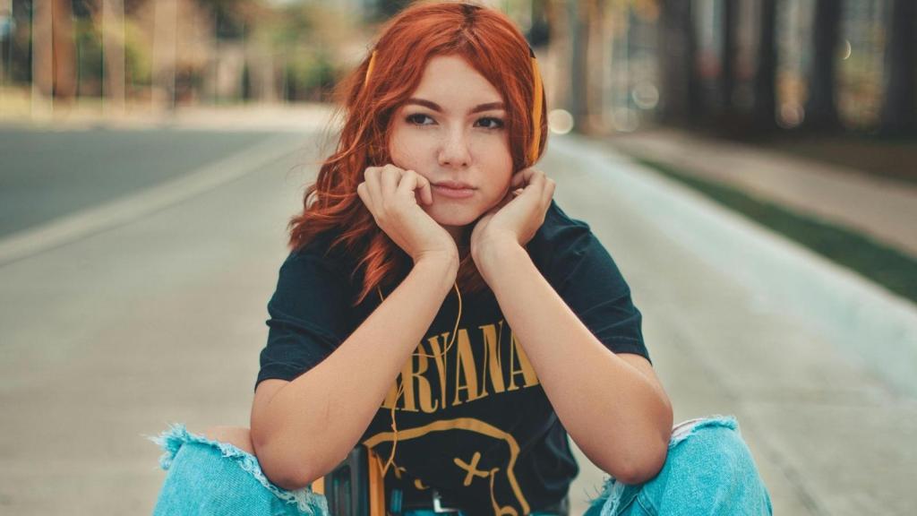 Red-headed woman listening to music in her Nirvana tee