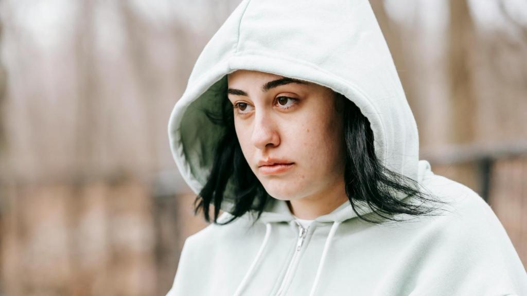 troubled teenager wearing blue hoodie