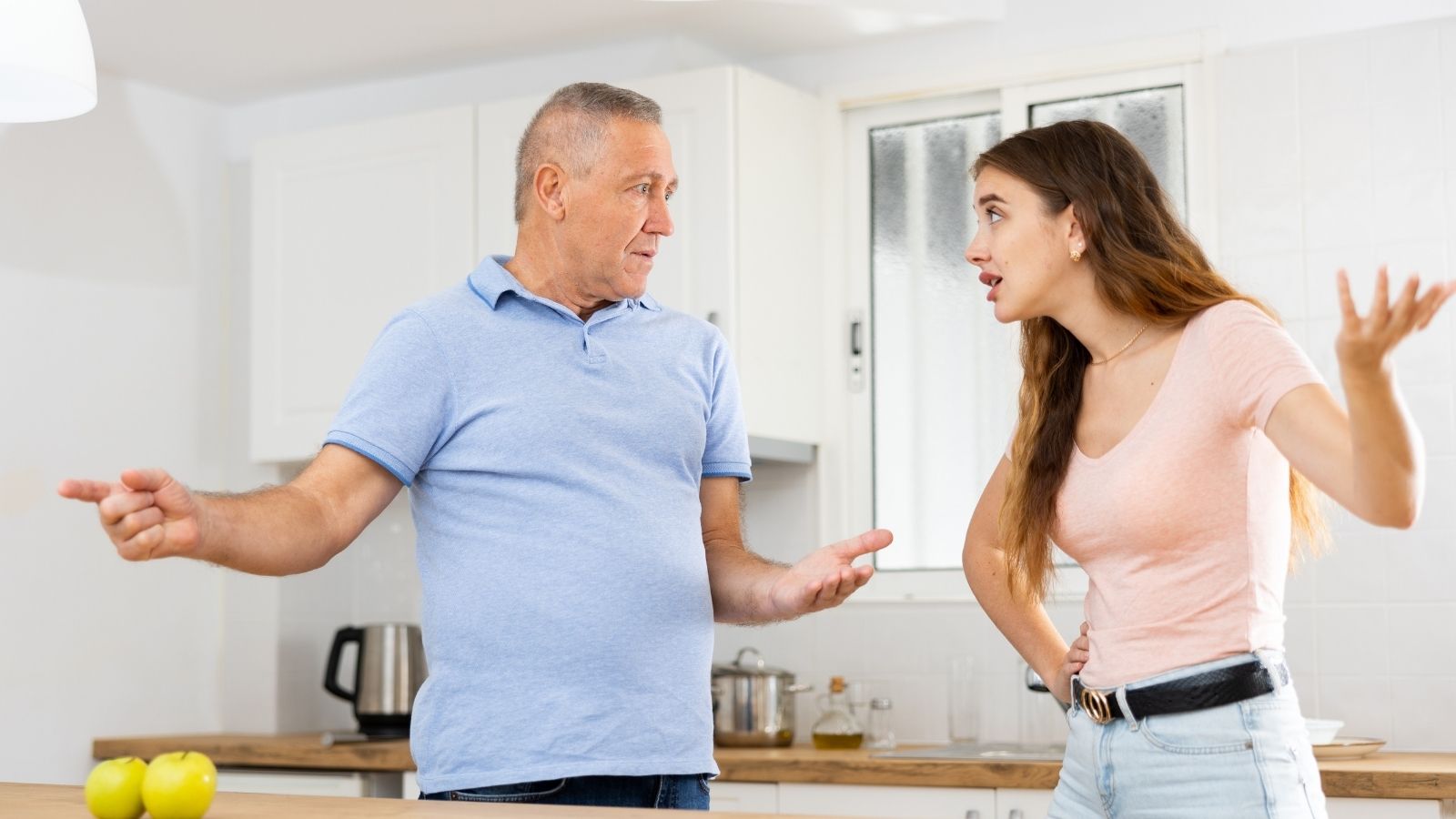 older dad arguing with teenage daughter