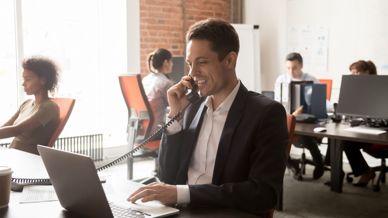 employees in an office on the phone and computers