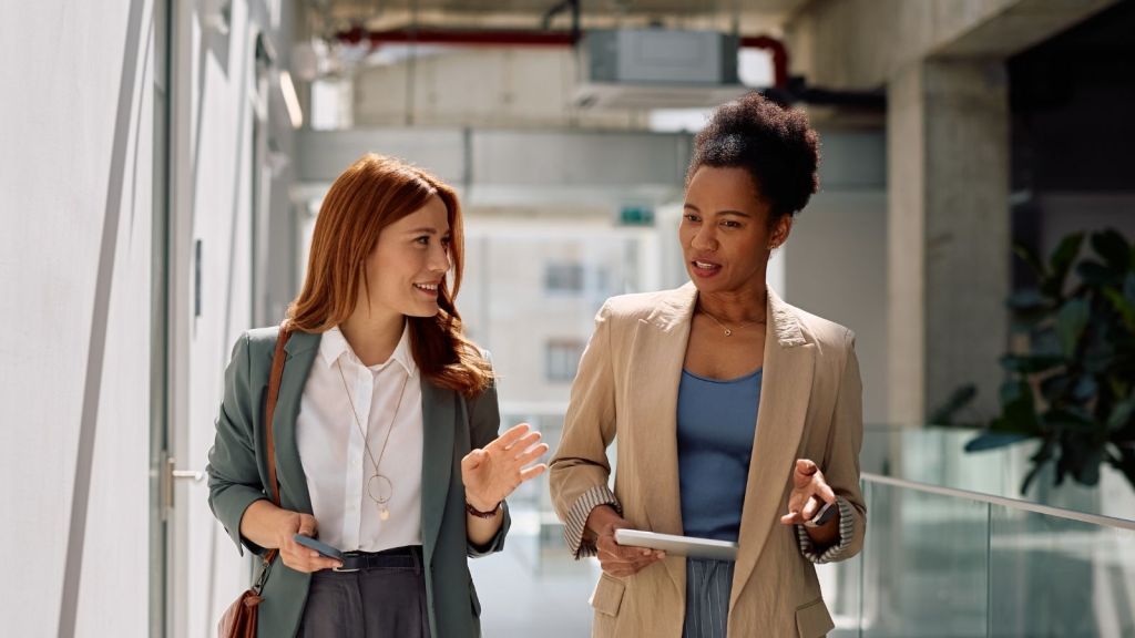 two businesswomen walking and talking