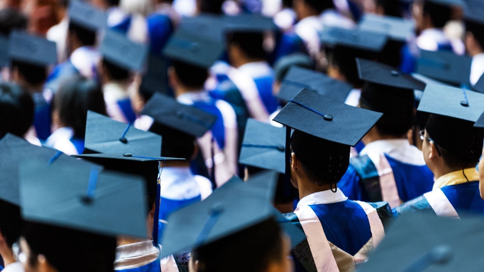 lot of graduates wearing graduation caps