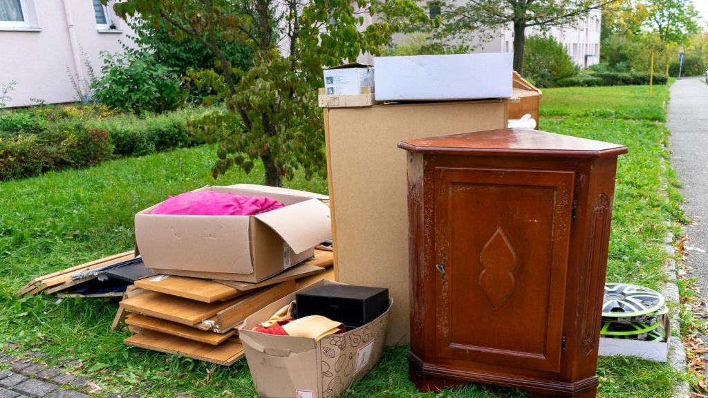 pile of furniture and belongings by the curb