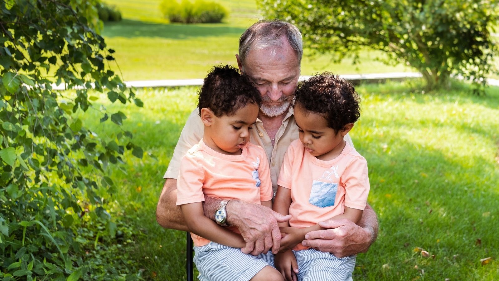 older man with twin toddler boys
