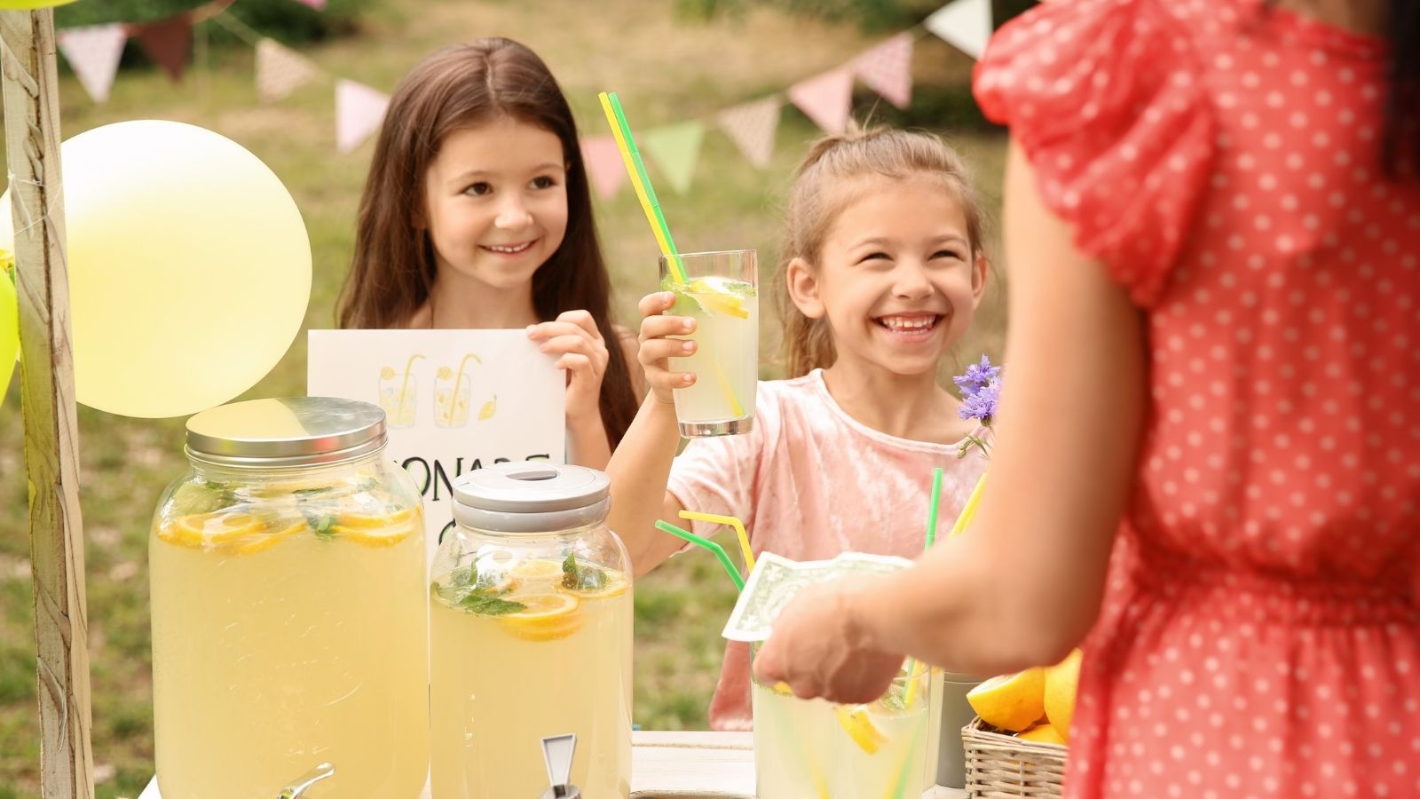 two little girls with a lemonade stand