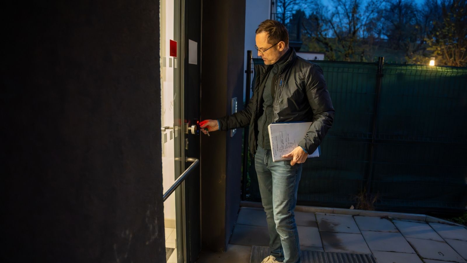 man unlocking apartment door at night