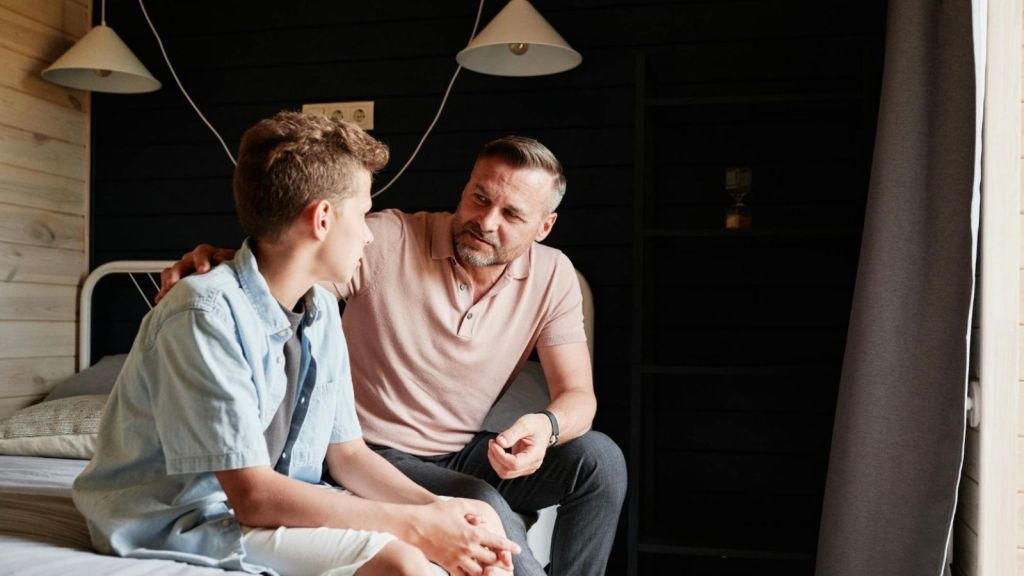 father and teenage son talking about something serious