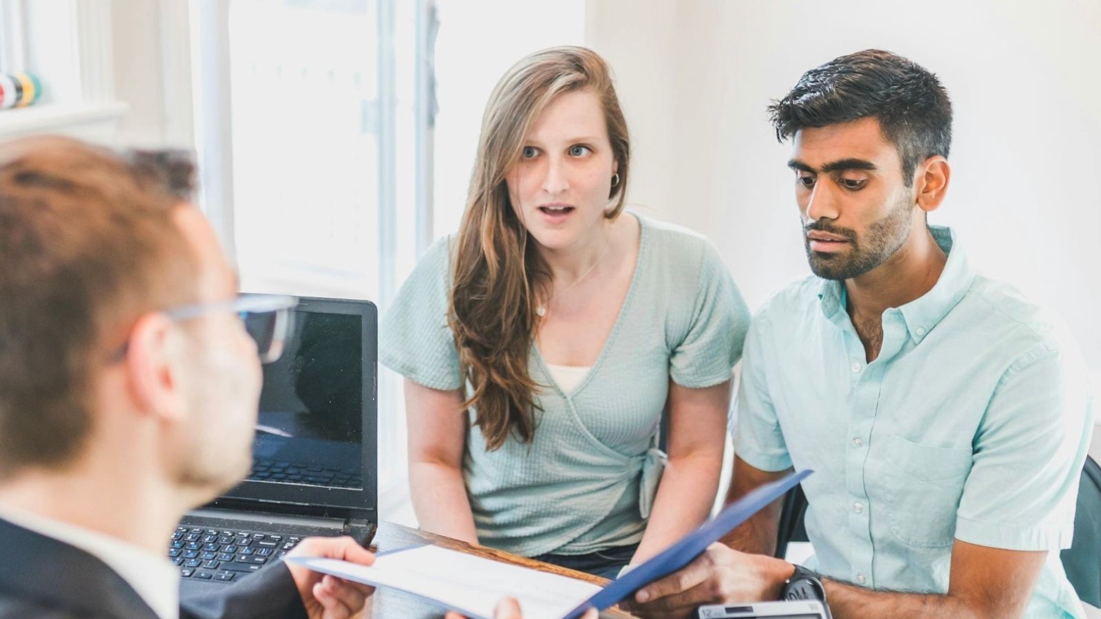 couple looking at lease with landlord