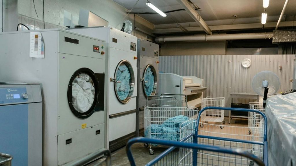 industrial washer and dryer in hotel laundry room