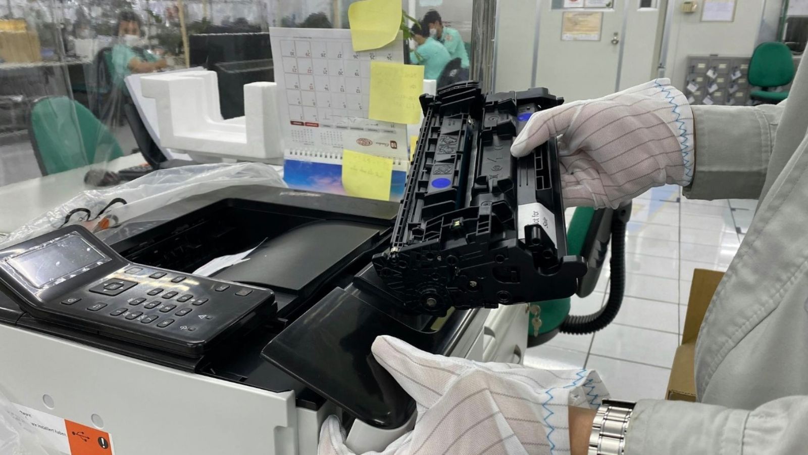 Manager’s Absurd Toner Rule Backfires Into a Massive Building Wide Cleaning Disaster person wearing gloves while changing toner in a printer