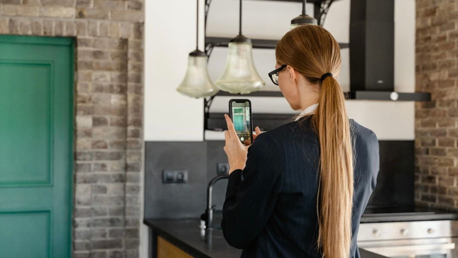 woman taking a picture inside an apartment