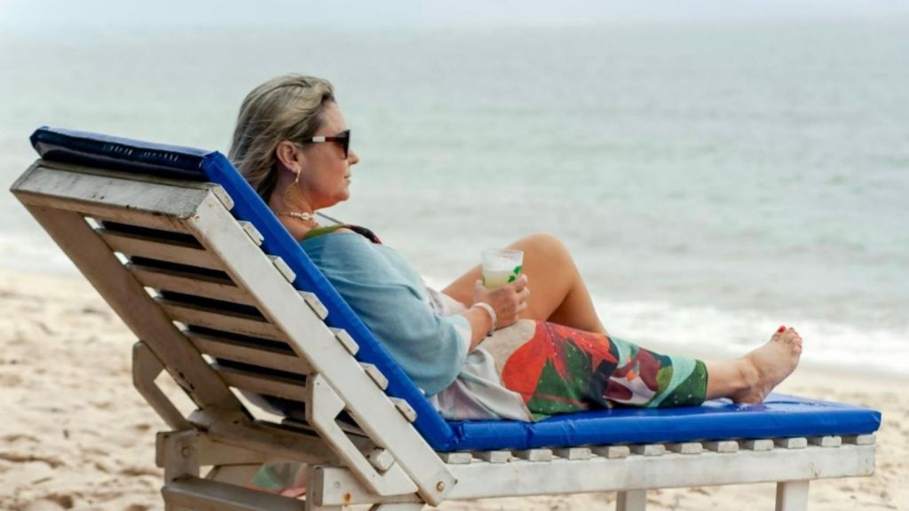 woman relaxing in a lounge chair at the beach