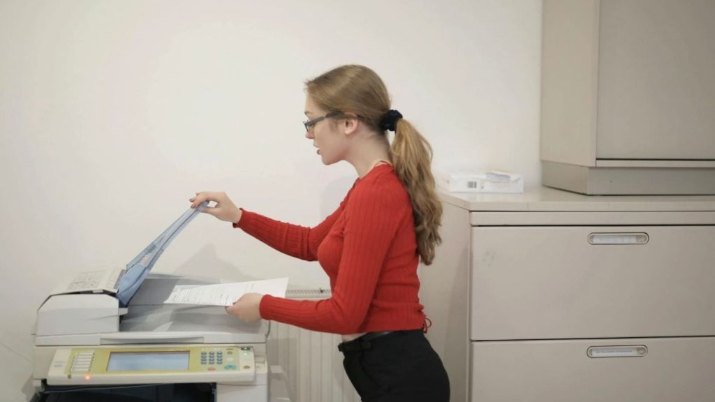 woman using a photocopier at work