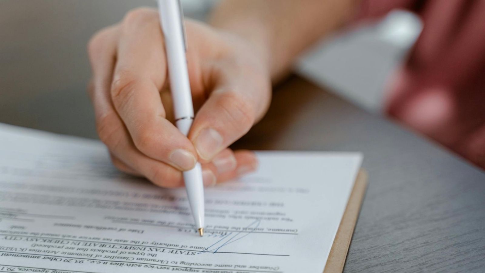 woman signing a document