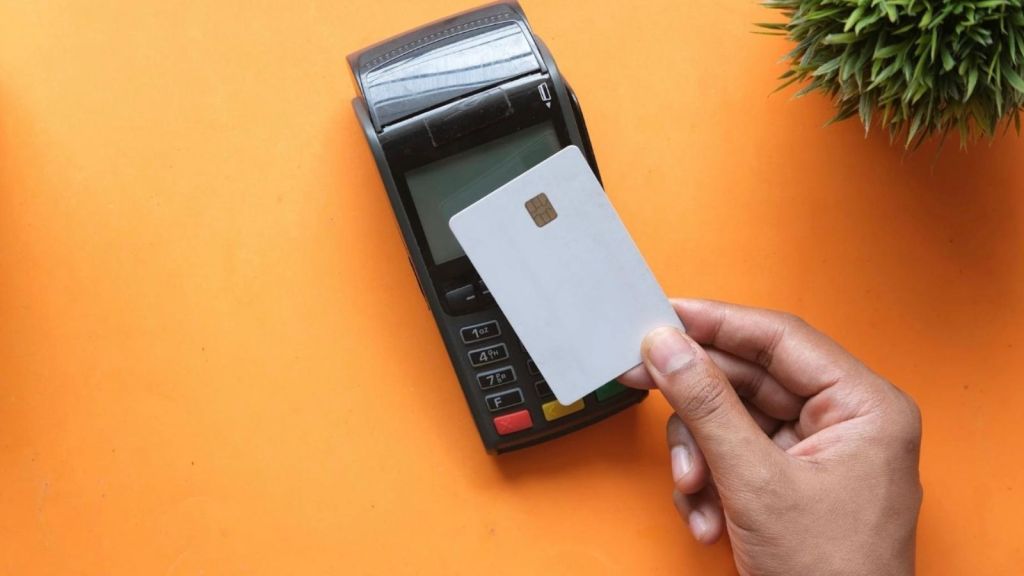closeup of man paying with a credit card