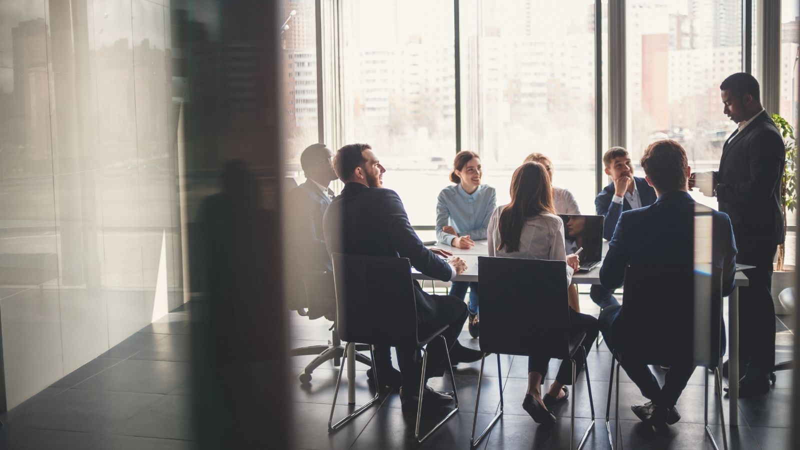 employees in a board room meeting at work