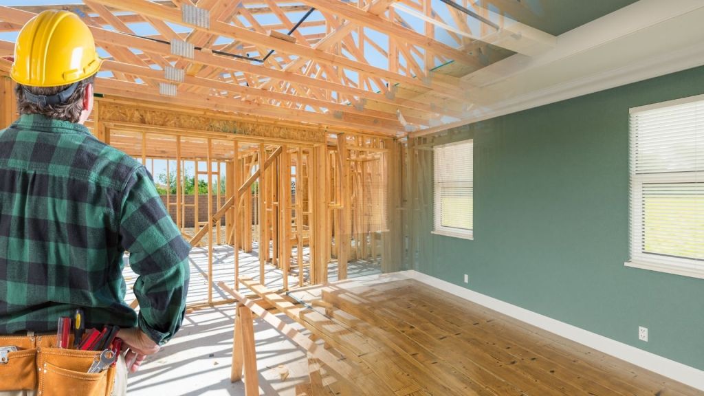 construction worker looking at a home renovation project in progress
