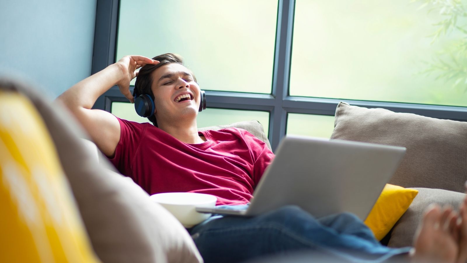college student relaxing on a couch and laughing