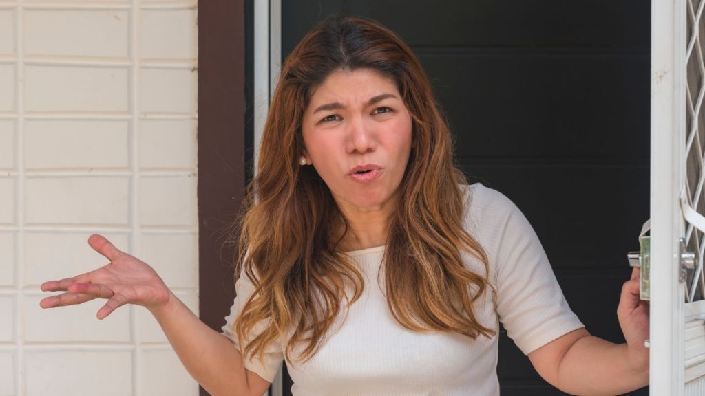 upset woman opening her front door