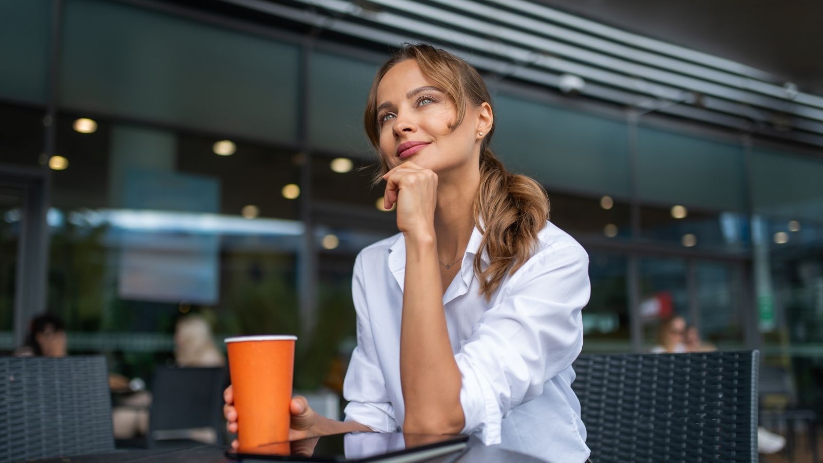 She Felt Nervous When a Man Followed Her Into the Parking Lot, but Now She’s Wondering If She Overreacted woman sitting outside at a cafe