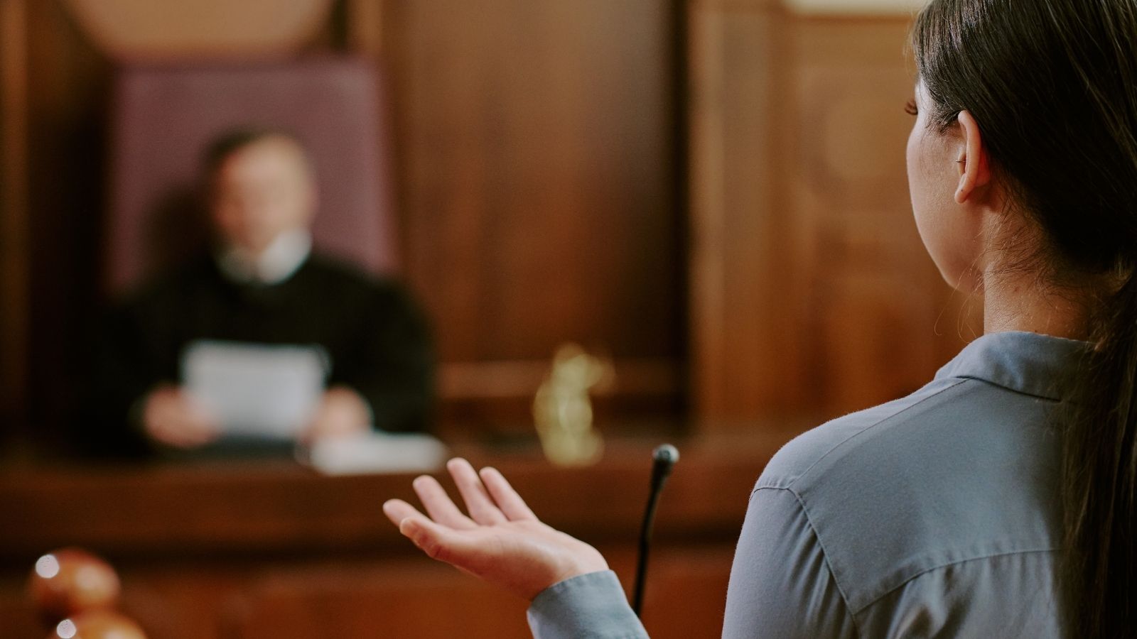 woman talking to a judge in a courtroom