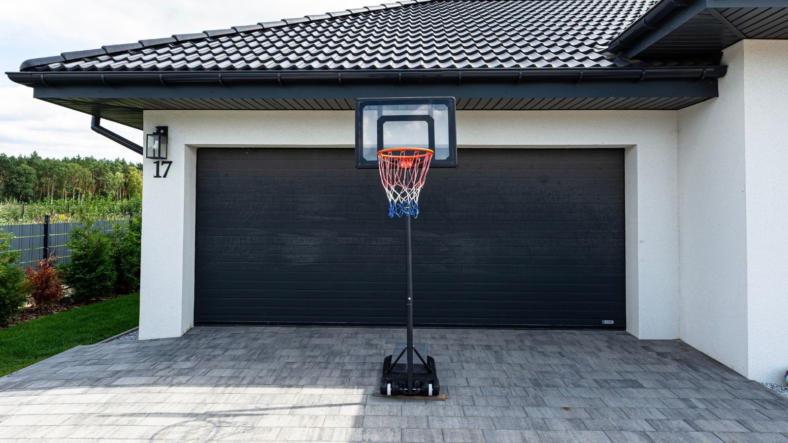 A Homeowner Lowered His Basketball Hoop to Protect Vehicles From High Winds—Until His Neighbors Clamped Down on the Eyesore portable basketball hoop in a driveway