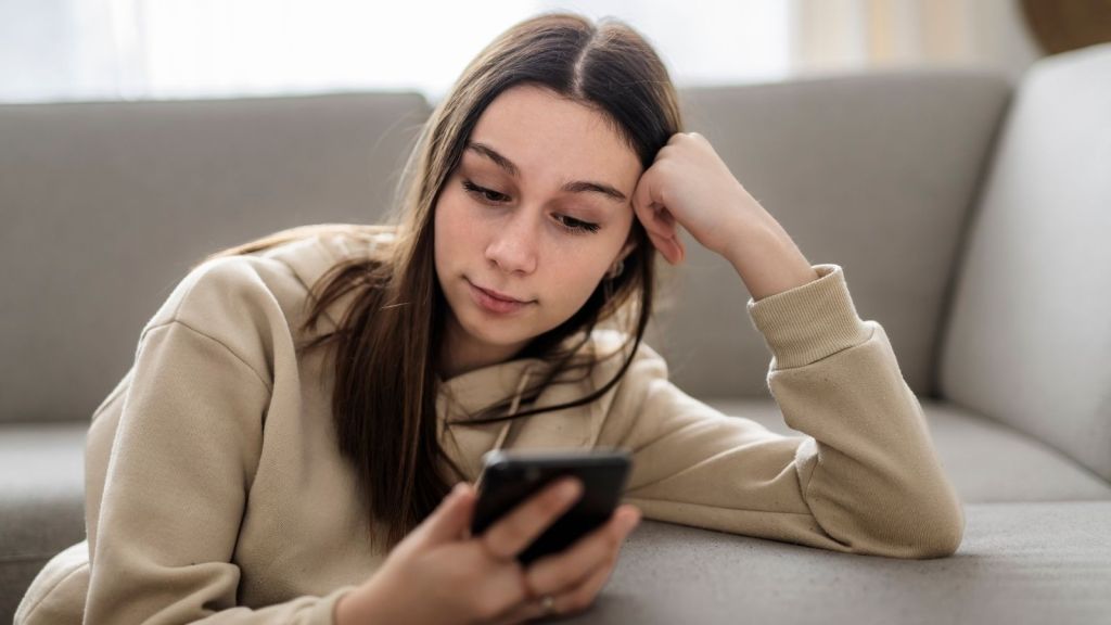 teenage girl looking at her phone