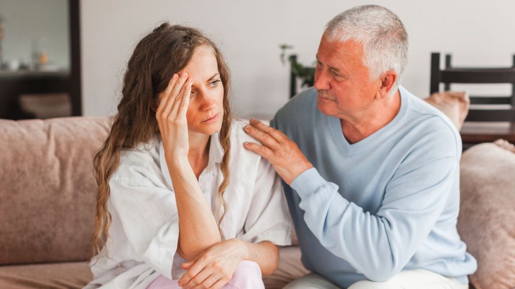 elderly father and stressed out adult daughter