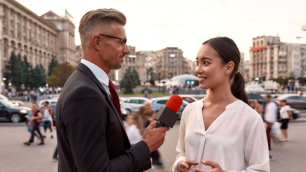 woman being interviewed by a news reporter
