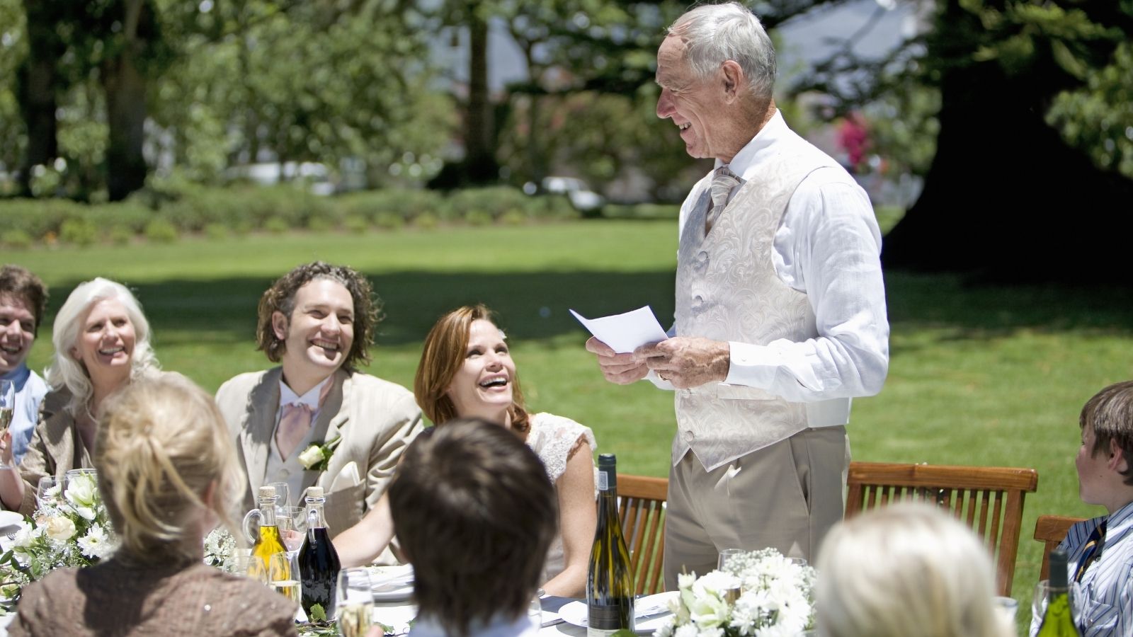 A Couple Pulled Off a Flawless, Stunning Wedding—Until the Father of the Bride Took the Microphone and Ruined the Reception older man giving a speech at an outdoor wedding