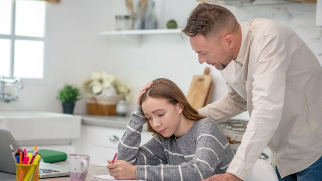 father talking to teenage daughter