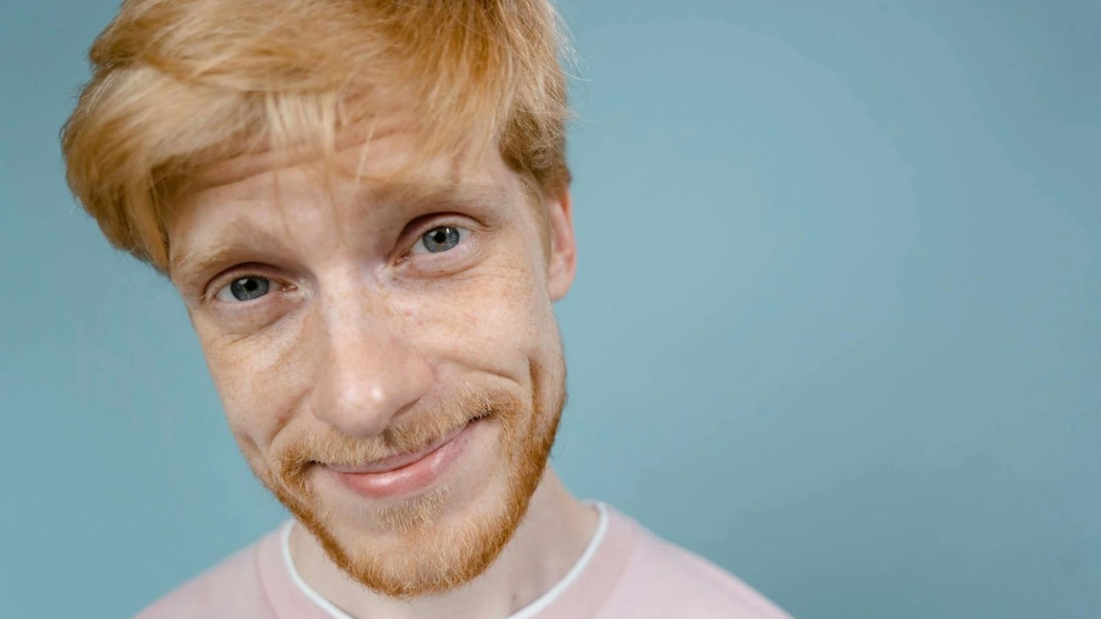 man with a mischievous grin