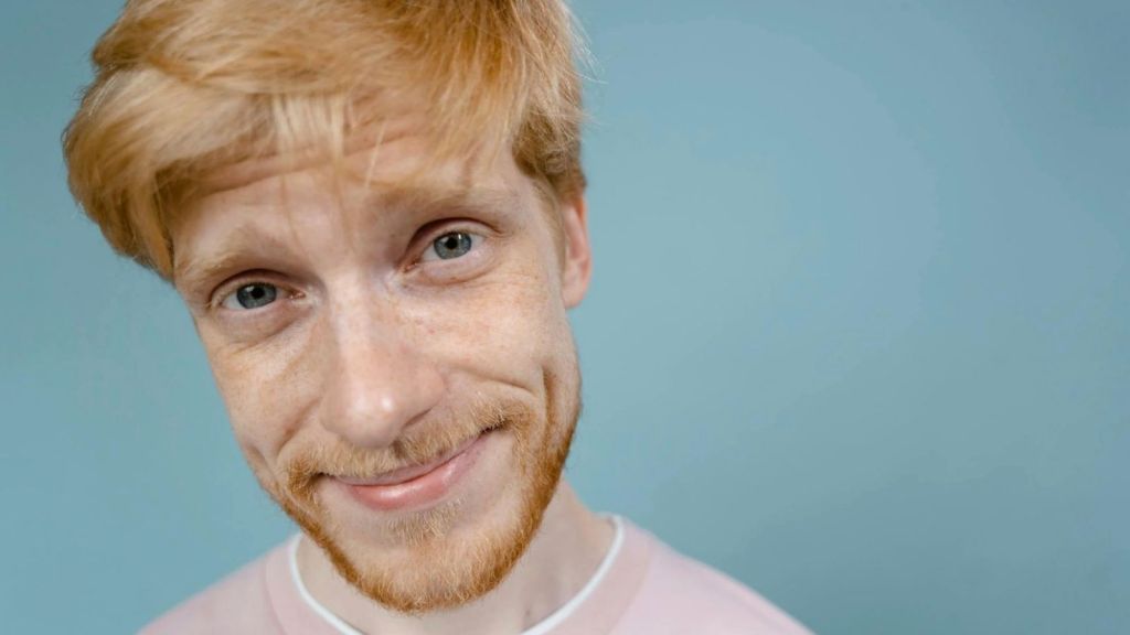 man with a mischievous grin