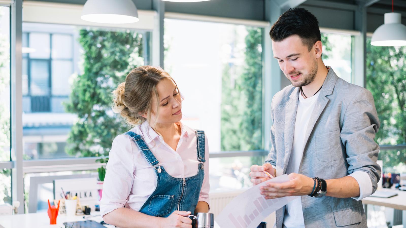 Man showing a document to a coworker