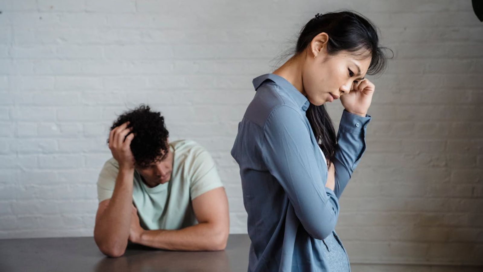Man and woman feeling sad and having a quiet argument