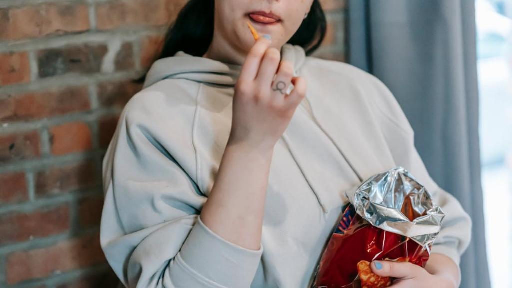 Woman eating chips from the bag