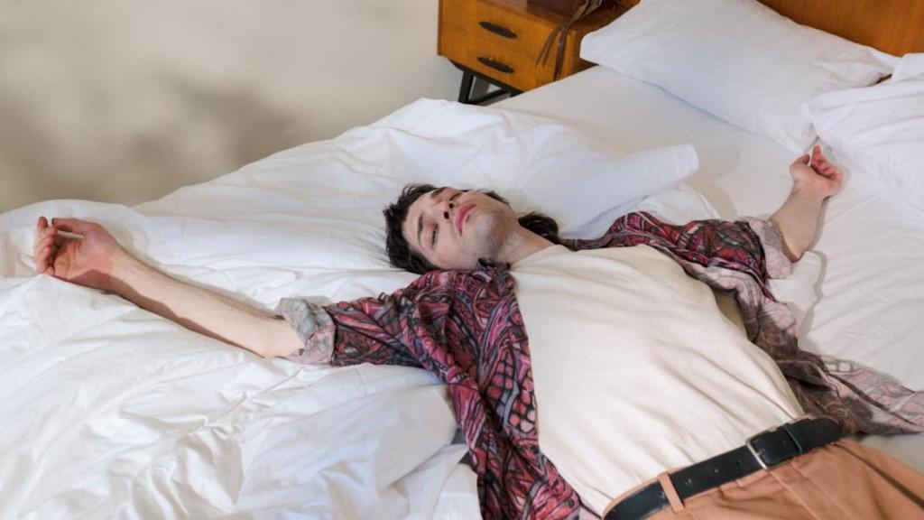 Tired man lying on bed and sleeping