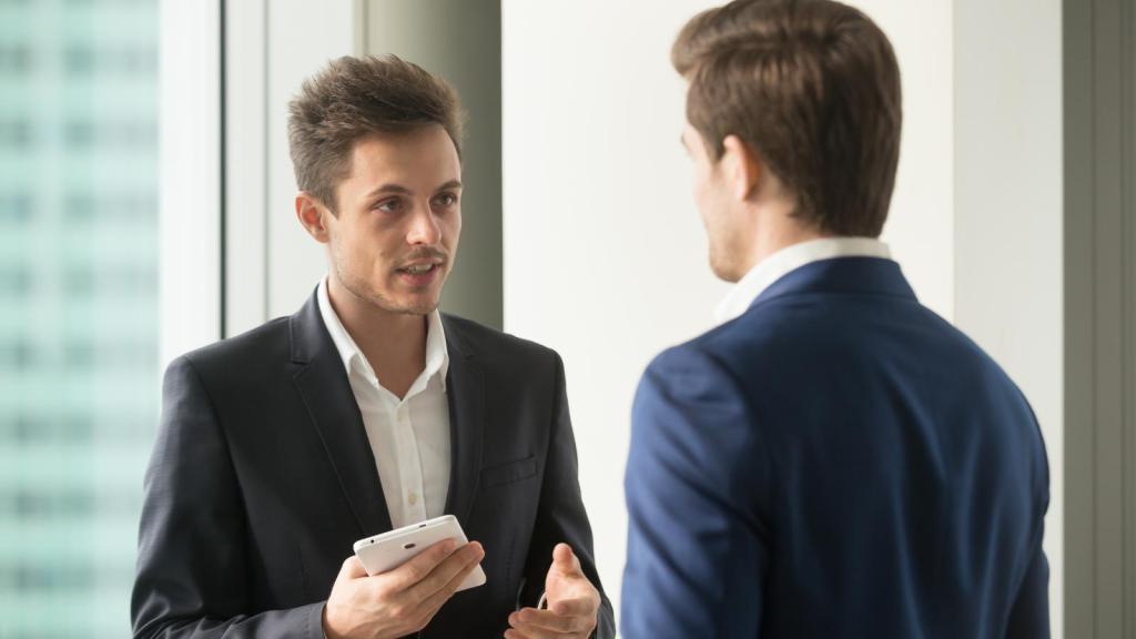 Two men in business attire talking to each other