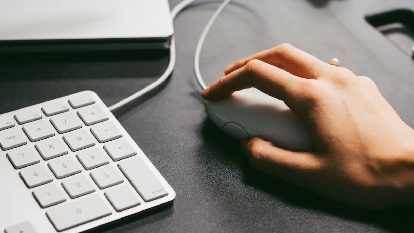 Person clicking a button on the mouse