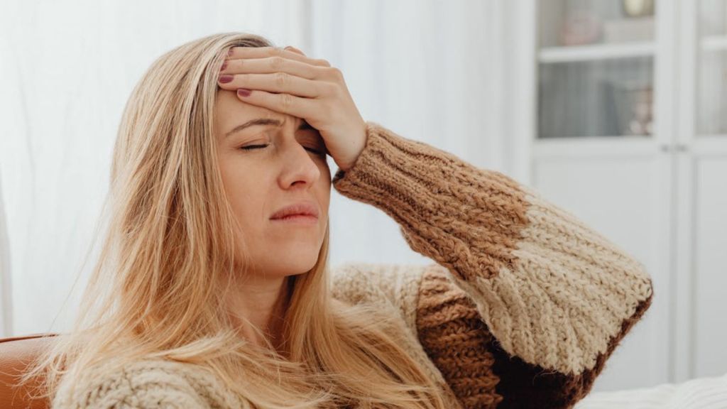 Woman having a migraine attack