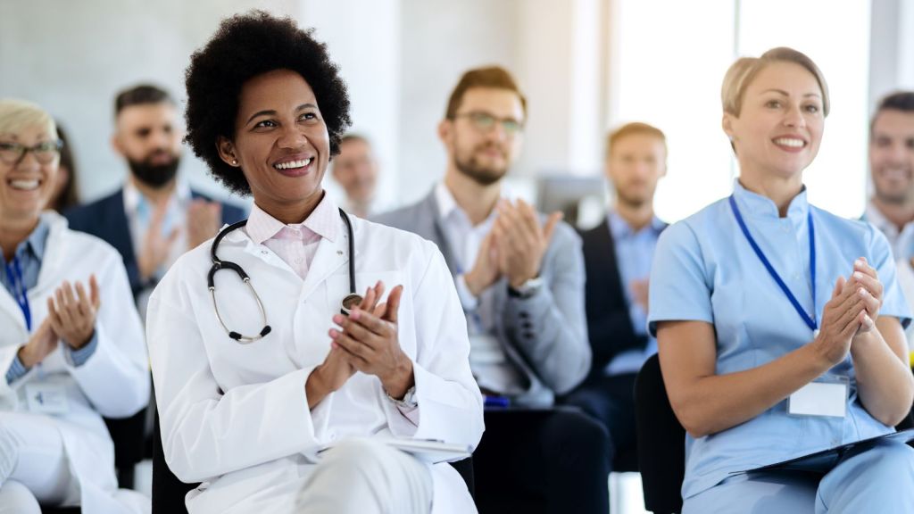 Healthcare professional clapping and smiling