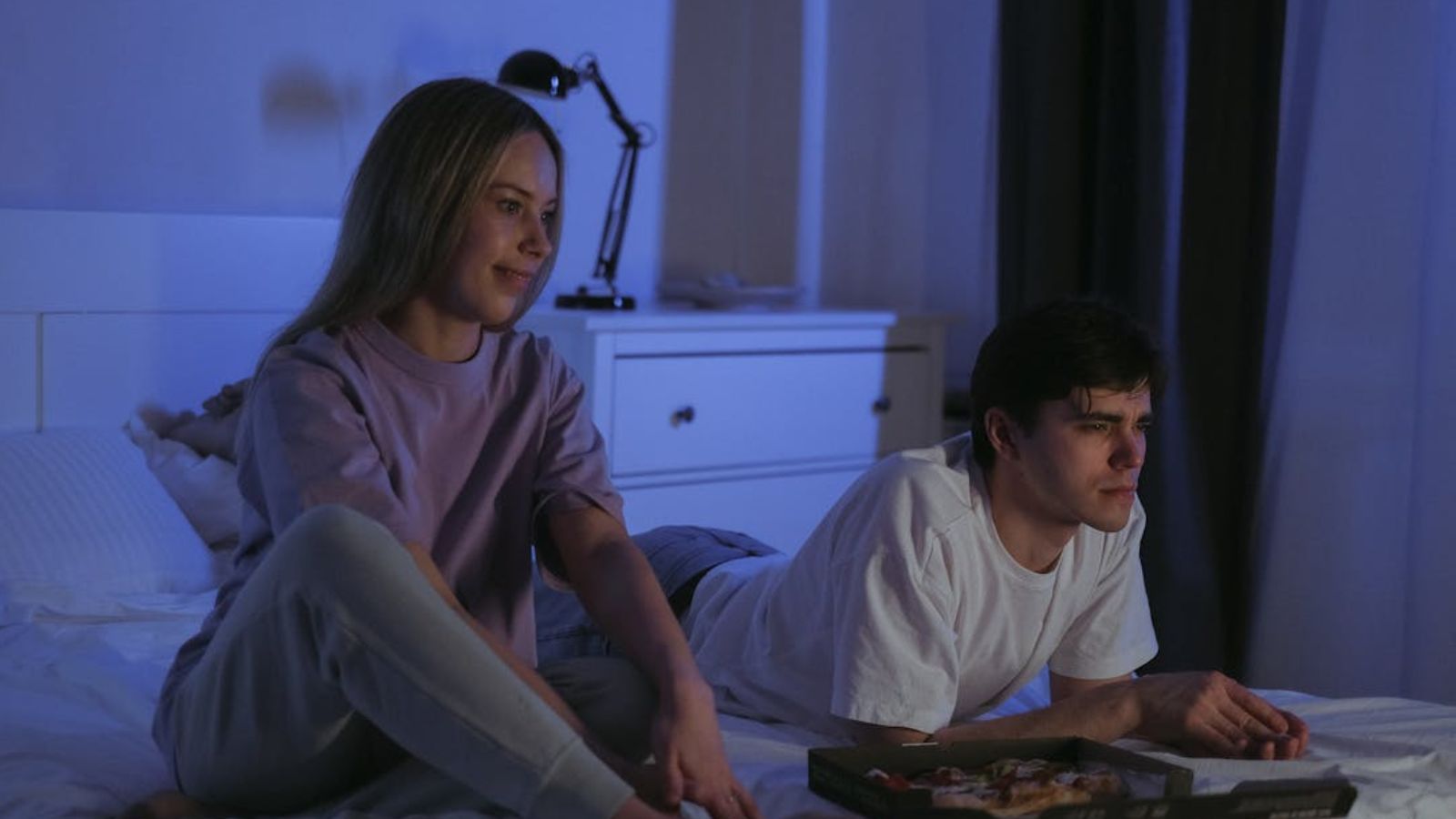 Man and woman watching TV in a dark room