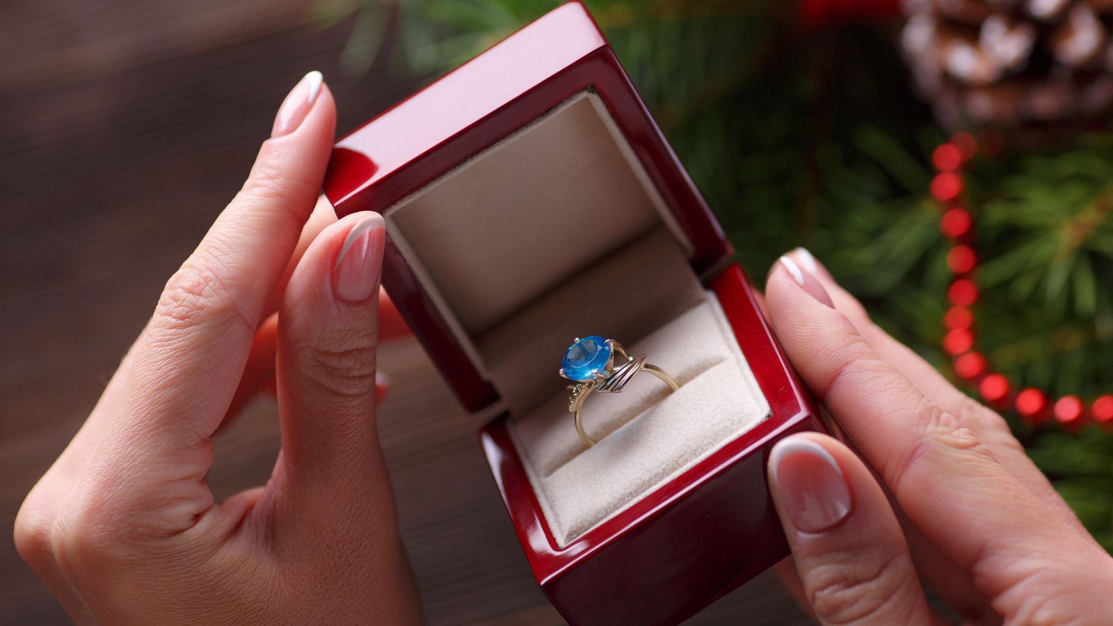 Person's hands holding a box with ring in it