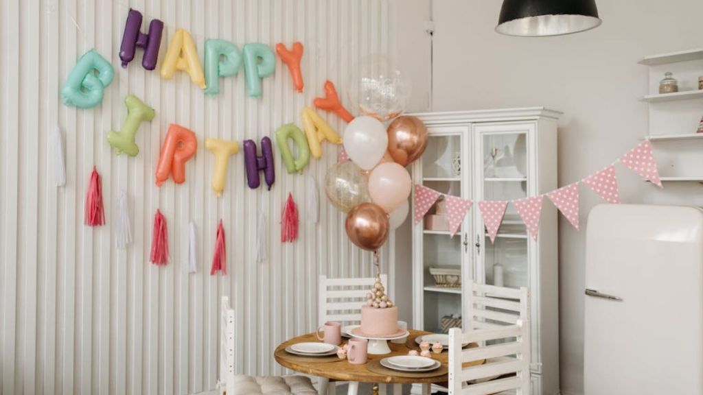 A minimalist house decorated with birthday decors, cake, and table setup