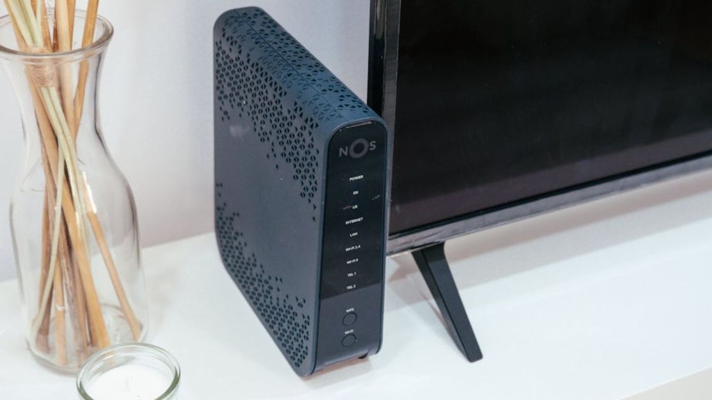 A sleek home technology setup featuring a router, glass decoration, and television