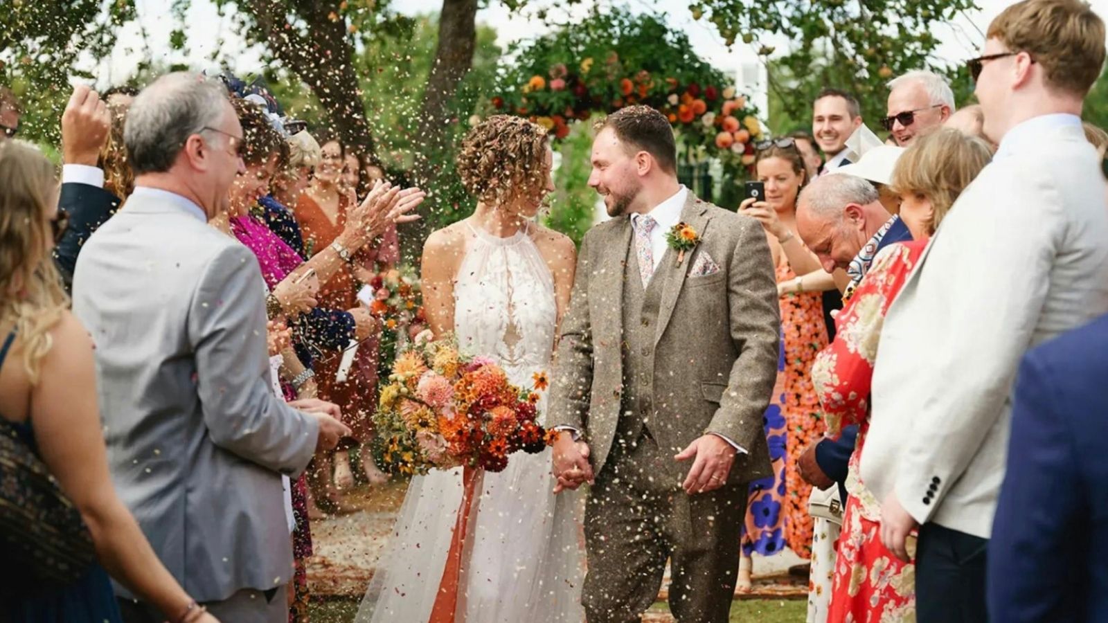 Woman Keeps List of Father in Law’s Wedding Behavior, Then Discovers Sister in Law Has an Even Longer One wedding guests throw rice at bride and groom