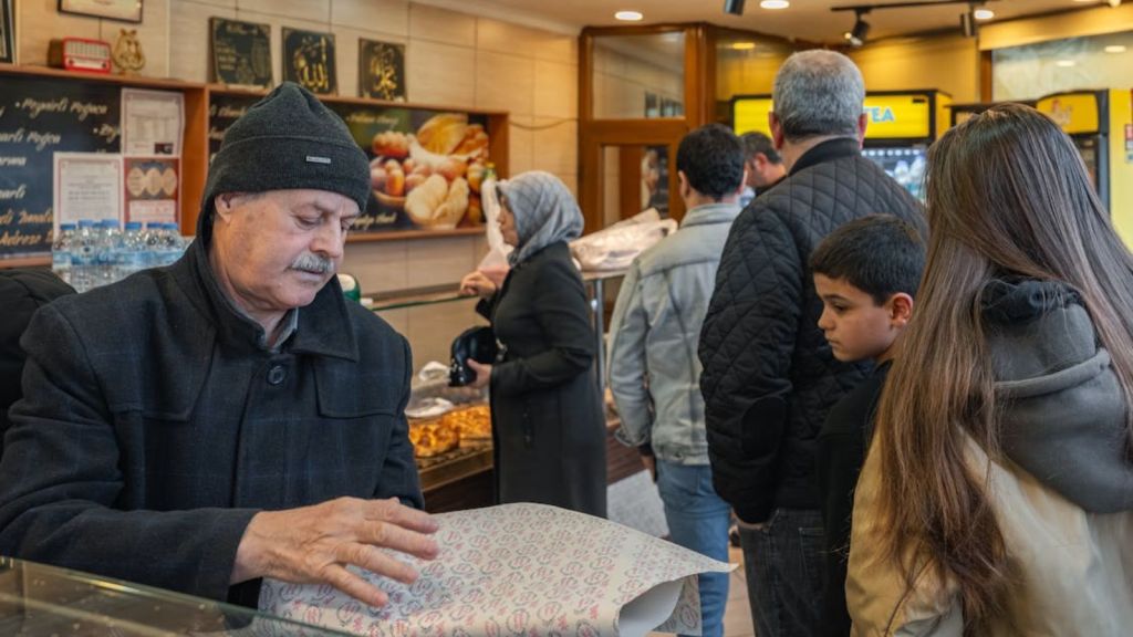 A long line of customers in a bakery